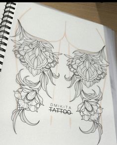 an open notebook with tattoos on the pages and flowers drawn on it's cover