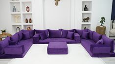 a living room filled with lots of purple furniture