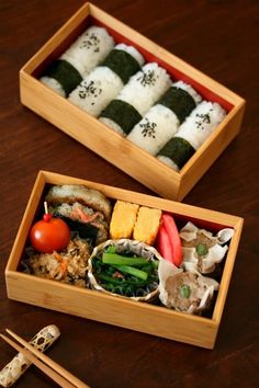 two wooden boxes filled with different types of sushi