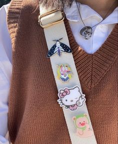 a person wearing a hello kitty lanyard with buttons on it's collar and tie