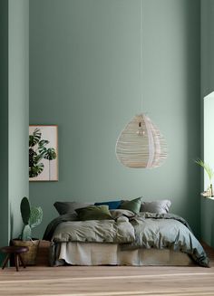 a bedroom with green walls and wooden floors is featured in the instagram post on instagram