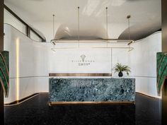 a marble counter top sitting in the middle of a room with gold trimmings