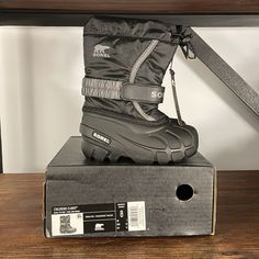 These Sorel Boots Are New In Box. Color On Box Is Black/City Gray. Style Is “Flurry “. Size 8 (Toddler). New With Tags And Box. Please See Close-Up Picture Of One Boot Where There Appears To Be A Pin Prick Hole At The Top Where A Security Tag Was Attached. Non-Smoking Home. **Please Note I Will Wrap Box In Brown Shipping Paper To Mail. Black City, Sorel Boots, Close Up Pictures, Box Color, Rain And Snow Boots, Snow Boots, Black Gray, Close Up, Gray Color