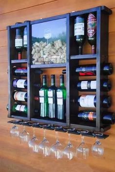 a wall mounted wine rack filled with bottles and glasses