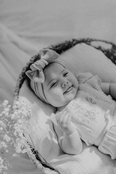 a black and white photo of a smiling baby