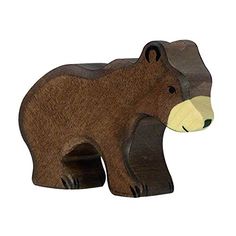 a wooden toy bear is shown on a white background