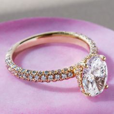 a close up of a ring on a pink surface