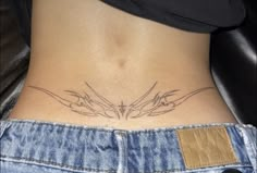 a woman's lower back tattoo with two birds on her stomach and an arrow in the center