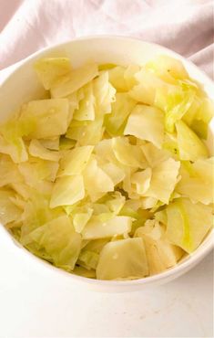 a white bowl filled with chopped cabbage