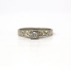 a white gold ring with an old - fashioned style diamond set in the shans