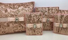 four decorative pillows with bows and sequins on the front, one in pink