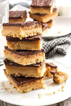 a stack of peanut butter bars sitting on top of a white plate