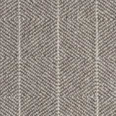 a close up view of a herringbone pattern on a wool suiting material background