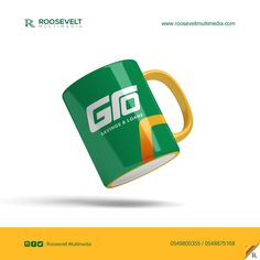 a green and yellow coffee mug with the word go on it is flying through the air