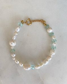 The Crystal Bracelet is made of freshwater pearls, small colorful beads and golden parts that makes ideal for all the summer time. Its handmade and adjustable with the extra chain at the connection. INGREDIENTS 🍋Stainless steal golden lobster clasp 🔮18k gold plated Chain 🧿6mm Glass bead in aquamarine  🌵5mm Gold Silver Stainless Steel Round Claw Spring 🍄Freshwater pearls in different sizes and shapes LENGHT: - Every anklet has length of 18 cm to 20 cm (Adjustable bracelet) - If you would like to have a different size, let us know with a message before your order. FUN FACT: Crystal glass beads are made of leaded glass and are very shiny. They are typically faceted for additional shine, and glitter like a diamond or other precious stone ♡ CARE TIPS - avoid contact with cosmetics and perf Adjustable Crystal Bracelet With Pearl Charm, Beaded Baroque Pearl Bracelet, Handmade Adjustable Baroque Pearl Beaded Bracelets, Adjustable Baroque Pearl Beaded Bracelets, Pearl Beaded Bracelets With Faceted Beads, Pearl Crystal Bracelet With Faceted Round Beads, White Pearl Bracelet With Faceted Beads, Bracelets Unique, Bracelet Pearl