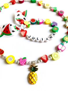 Hello everyone, welcome to my shop. This is a personalized/customized fruit stretch bracelet and necklace set for little girls. Perfect for girls as everyday summer jewelry. I will choose random fruits and ribbons to make your bracelet, I will always try to get as close as possible to original but stock may vary. I will need to know the name of your child (leave me a note at checkout section) and your child's wrist. (in inch- find your size in the menu) Can be made without the ribbon, leave me a Playful Colorful Jewelry Gift, Adjustable Rainbow Color Playful Jewelry, Summer Beach Jewelry With Fruit Design, Summer Green Playful Jewelry, Playful Green Summer Jewelry, Fun Summer Necklaces For Gifts, Playful Rainbow Jewelry For Birthday, Cute Personalized Summer Bracelets, Personalized Playful Rainbow Jewelry