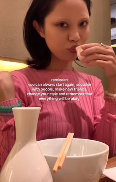 a woman eating food from a bowl with chopsticks in her mouth and an ad on the side