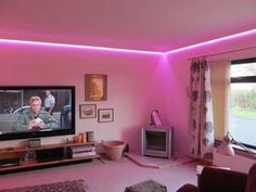 a living room filled with furniture and a flat screen tv