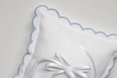 a white pillow with a bow on it