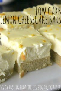 a white plate topped with slices of lemon cheesecake bars