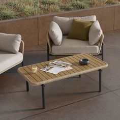 two chairs and a coffee table on a patio