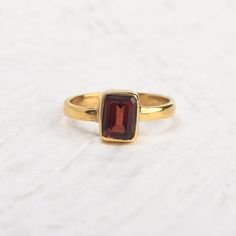 Simple 14k gold vermeil promise ring with single red garnet stone. Tiny stackable everyday ring, January birthstone ring, wedding anniversary ring, gift for the sweetheart. Specifications :--- ✔️ Made to Order ✔️ Metal Options ~ 14K Gold Vermeil  ✔️ Gemstone : Garnet ✔️ Gemstone Size : 6mm x 8mm ✔️ Handmade Jewelry ❤ Everything in my shop is handmade. ❤❤ Each item will be beautifully packed in a recycled box.  I happily take all customized orders. Q: What is 14k gold vermeil? A. Gold vermeil is a type of gold jewelry made to last. The base metal is Sterling Silver which means your piece is made from precious metals only. A thick layer of gold is then electroplated over the base metal. While it may sound similar to gold plated jewelry, gold vermeil jewelry has a much thicker layer of gold. Gold Stackable Ruby Birthstone Ring, Classic Ruby Stackable Rings As A Gift, Classic Ruby Stackable Rings For Gift, Classic Gold Stackable Ruby Ring, Garnet Birthstone Ring In Yellow Gold, Classic Stackable Ruby Ring Gift, Stackable Gold Ruby Ring For Gift, Gold Garnet Birthstone Ring Gift, Garnet Stackable Rings As A Gift