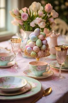 the table is set for easter dinner with pink and white flowers in the vases