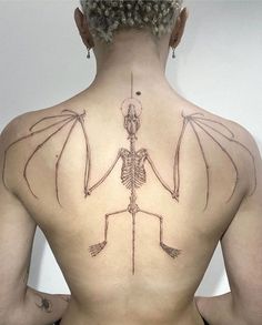 a woman with a skeleton tattoo on her back