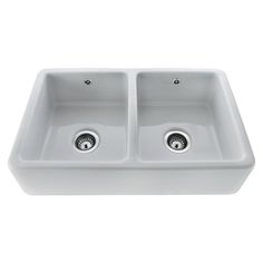 a white double bowl sink with two faucets on the side and one drain