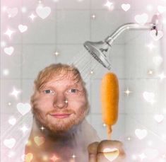 a man holding a toothbrush in front of a shower head with soap on it