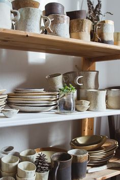 a shelf filled with lots of plates and cups