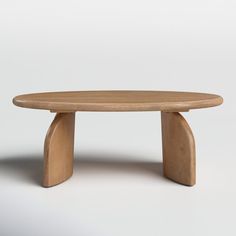 an oval wooden table with curved legs