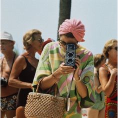 1972: Princess Grace of Monaco taking a photograph at a swimming competition at Palm Beach, Monte Carlo. (Photo by Hulton Archive/Getty Images) As an authorized Getty Images Gallery partner, we offer premium quality prints based on the original negatives and plates from Getty’s darkroom. Photographic prints are C-types printed on Fujicolor Crystal archival paper for highest quality with an embossed Getty Images Archive stamp applied to the lower right margin. Accompanied by a Certificate of Auth Slim Aaron, Holding A Camera, Princess Grace Kelly, Celebrity Style Icons, Slim Aarons, Vogue Uk, Vogue Australia, Princess Grace, Ansel Adams