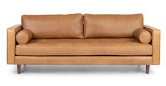 a tan leather couch with two pillows on it's back and one arm facing the camera