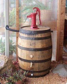 an old wooden barrel with a red faucet on top