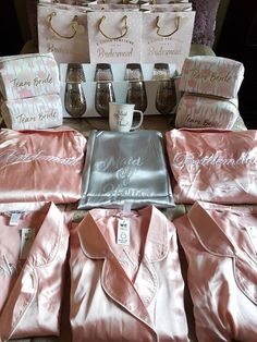 pink satin robes and matching pillows are on display at a bridal party or wedding