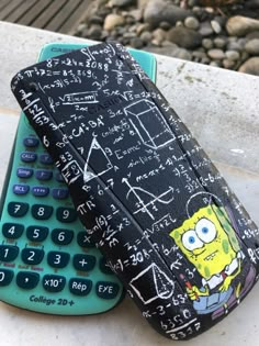 a cell phone case sitting next to a calculator