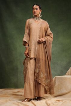 Peachish brown short kurta with placement floral embroidery. Paired with tired gharara and embroidered dupatta. - Aza Fashions Eid Wedding V-neck Palazzo Set, Designer V-neck Sharara For Eid, V-neck Sharara For Eid Wedding, Wedding Palazzo Set With Dupatta And V-neck, V-neck Palazzo Set With Dupatta For Wedding, Wedding Palazzo Set With V-neck And Dupatta, V-neck Sharara For Wedding And Eid, Eid Wedding V-neck Sharara, Elegant Brown Festive Sets