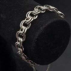 This vintage Monet bracelet features silver tone chain links and measures 7.5" L. It has a safety chain and is signed on both a hang tag and on the back of the clasp Classic Silver Chain Metal Bracelet, Sterling Silver Bracelet With Adjustable Chain For Formal Occasions, Adjustable Sterling Silver Formal Bracelet, Formal Metal Charm Bracelet With Adjustable Chain, Formal Metal Charm Bracelet With Chain, Metal Box Chain Link Bracelet, Vintage Silver Bracelets With Adjustable Chain, Classic Metal Chain Link Charm Bracelet, Nickel-free Metal Chain Link Charm Bracelet