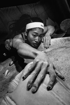 a black and white photo of a woman laying on the ground