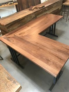 several tables and benches made out of wood with metal legs in a shop setting,