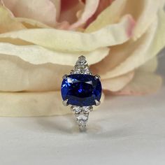 "The ring pictured is lab created blue sapphire with moissanite accents #7176 -Approximate total carat weight: approx. 3.56ctw diamond equivalent -Center Stone Size: 10x8mm - Approx. 3.00ct. diamond equivalent -Center Stone Shape: elongated cushion cut -Gem Type: lab created sapphire -Stone Clarity: VS2 -Stone Color: Blue -Moh's Scale: 9 hardness -Side Stones Size: 2 pear - 5x3mm - approx. 0.40ctw diamond equivalent -Accent Stones Size: 4 Rounds approx. .16ctw. diamond equivalent -Gem Type: mois Lab-created Sapphire Diamond Ring In Cushion Cut, Sapphire Ring With Radiant Cut And Accent Stones, Blue Sapphire Ring With Radiant Cut And Accent Stones, Sapphire Radiant Cut Ring With Accent Stones, Blue Radiant Cut Sapphire Ring In Sterling Silver, Classic Sapphire Ring With Moissanite Accent Stones, Blue Radiant Cut Diamond Ring With Accent Stones, Blue Radiant Cut Rings With Accent Stones, Radiant Cut Lab-created Sapphire Ring With Accent Stones