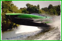 a green and black speed boat in the water