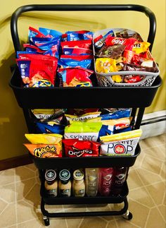 a cart filled with lots of food on top of a carpeted floor next to a wall