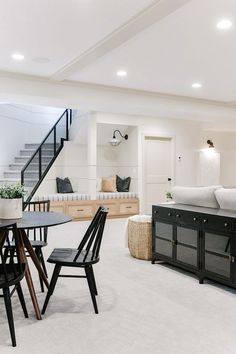 a living room filled with furniture and white walls