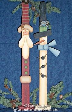 a close up of a christmas decoration made out of wooden sticks and other items on a blue background