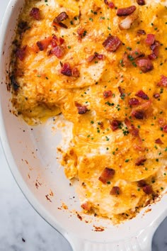 a casserole dish with meat and cheese in it on a marble countertop