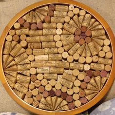 wine corks are arranged in a circular wooden tray on a tableclothed surface