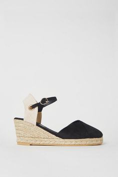 Closed-toe espadrille wedge sandals with a mid heel
Faux leather upper in a sleek black hue
Ankle strap with a buckle fastening for a secure fit
Woven rope-textured wedge heel and platform sole
Stylish yet practical for everyday wear
Effortlessly elevate your warm-weather looks with these chic espadrille wedges. The closed-toe design offers a refined touch, while the mid wedge heel provides a comfortable boost in height. Crafted from faux leather, these sandals exude a polished aesthetic that seamlessly transitions from casual daytime outings to evening occasions. Style them with a breezy sundress or cropped trousers for a touch of sophistication. Polished Aesthetic, Heeled Espadrilles, Oasis Fashion, Espadrille Wedge, Cropped Trousers, Toe Designs, Mid Heel, Espadrilles Wedges, Ankle Strap Sandals