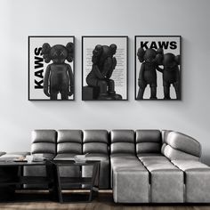 two black and white pictures hang on the wall above a couch in a living room